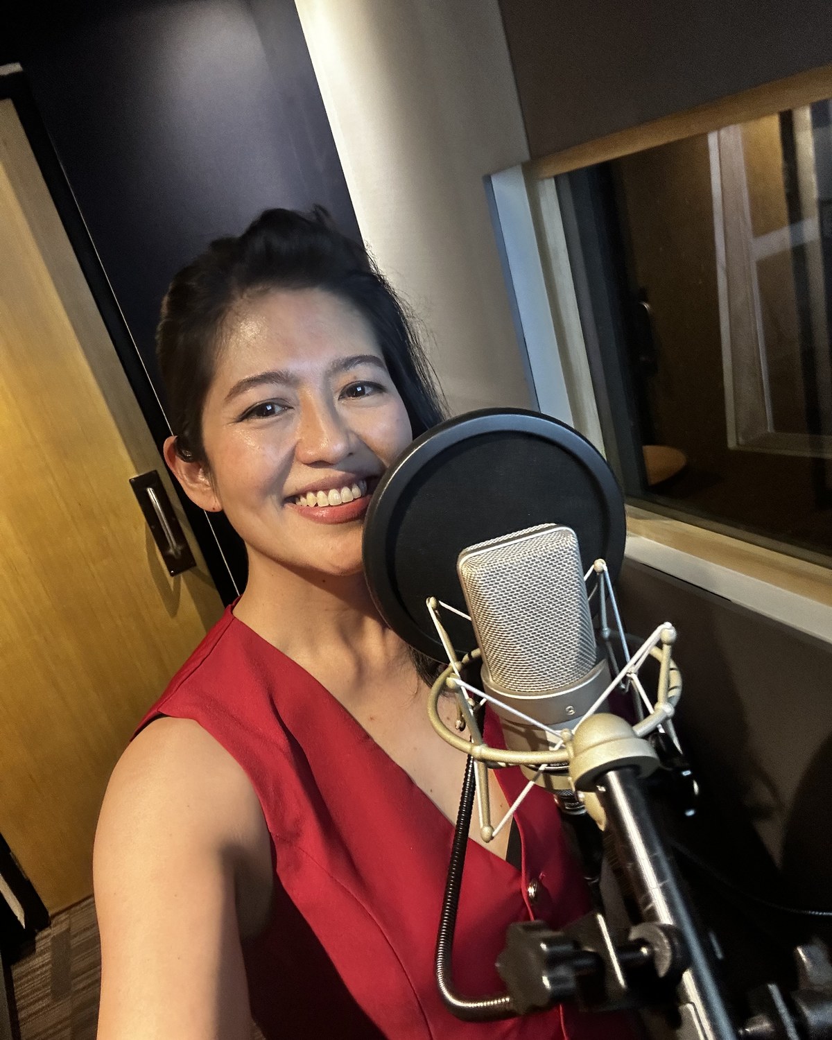 Kahna Velasco recording in a studio booth